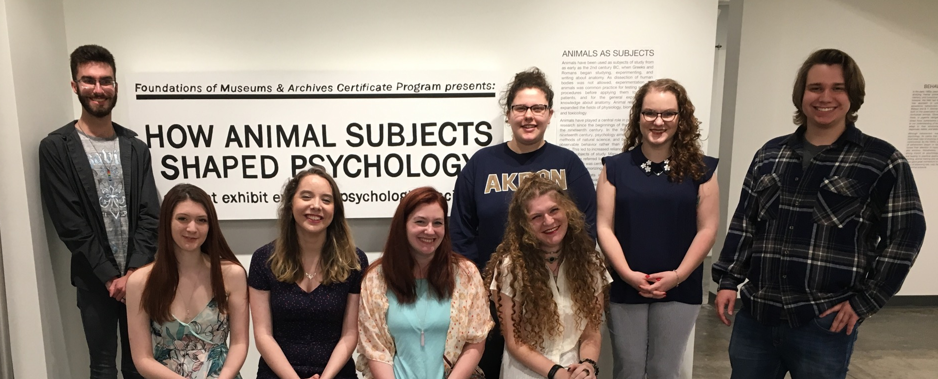 A group of students gathered in front of a museum exhibition